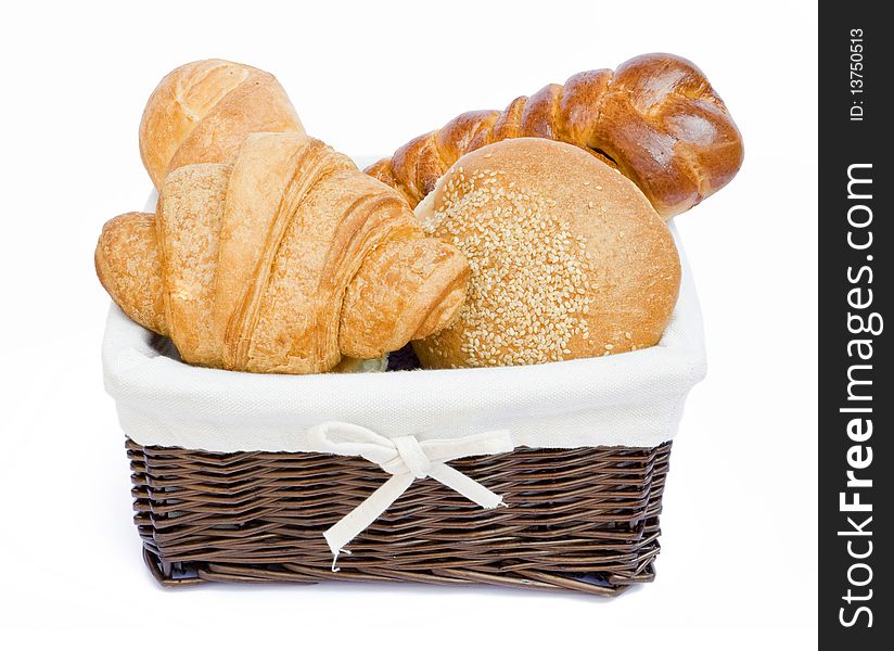 Fresh baked rolls in a basket on white. Fresh baked rolls in a basket on white