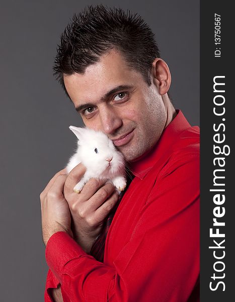 Handsome young man holding baby rabbit