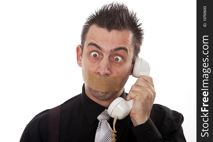 Funny businessman with tape on his mouth listening to someone on phone