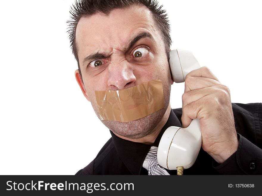 Funny businessman with tape on his mouth listening to someone on phone