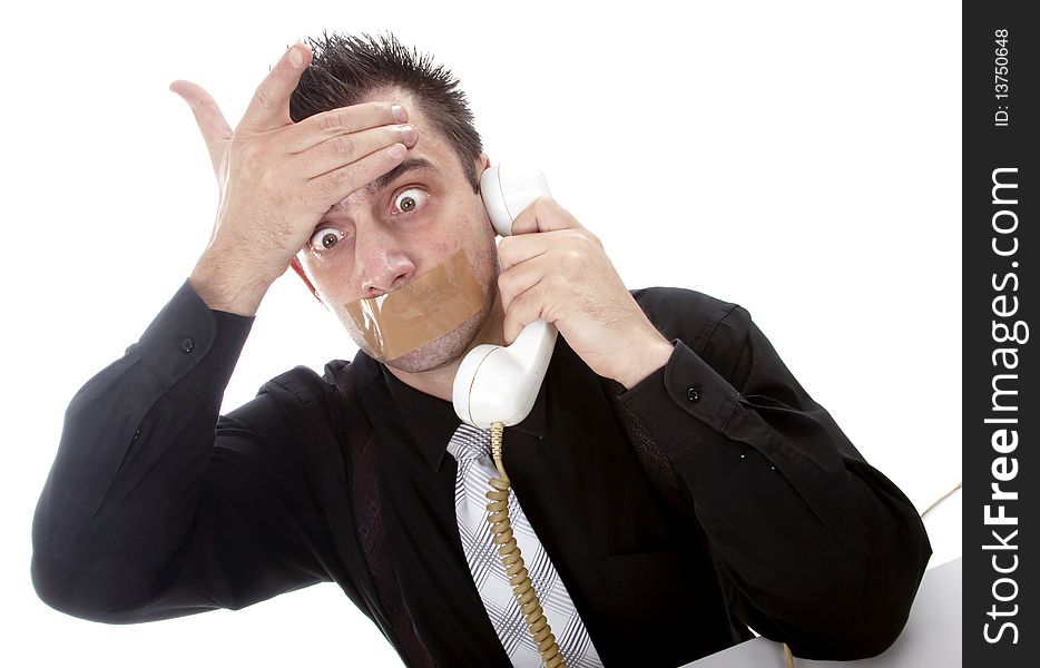 Funny businessman with tape on his mouth listening to someone on phone
