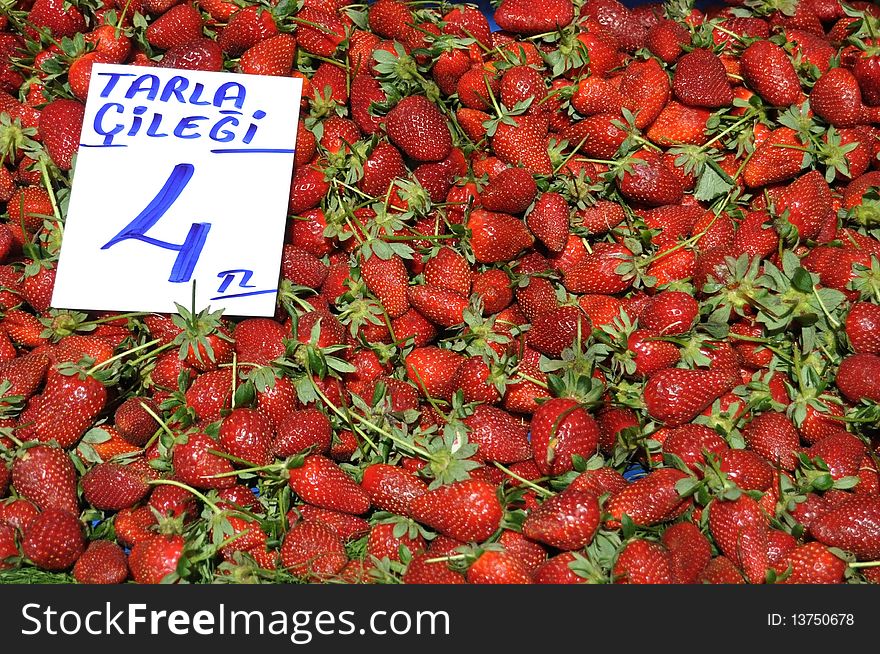 Strawberries on the market with pricetag. Strawberries on the market with pricetag