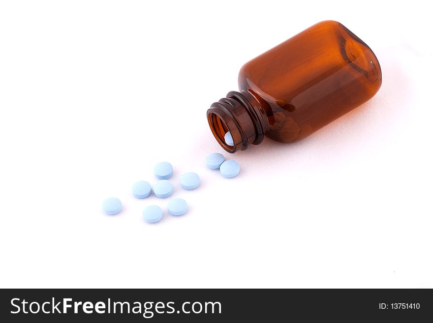 Pills and Open Bottle on islolated White Backgound