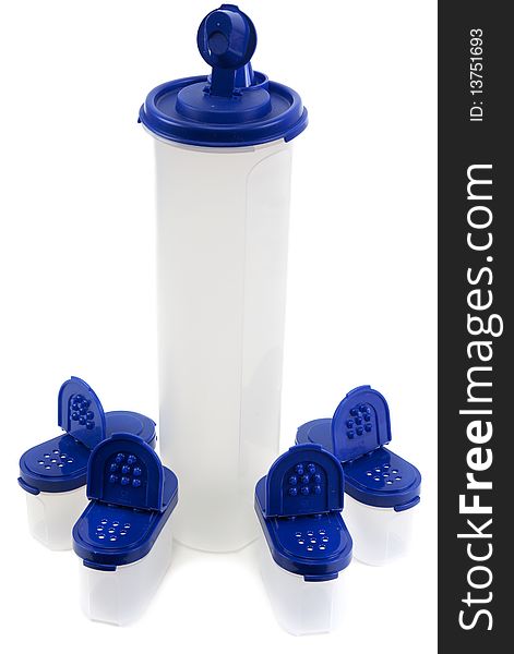 Saltcellar and plastic bottle from translucent plastic arts with blue lid on white background