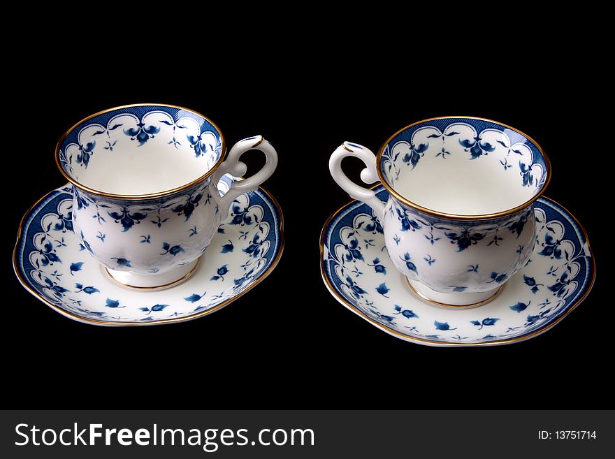 Two tea cups on saucer insulated on white background