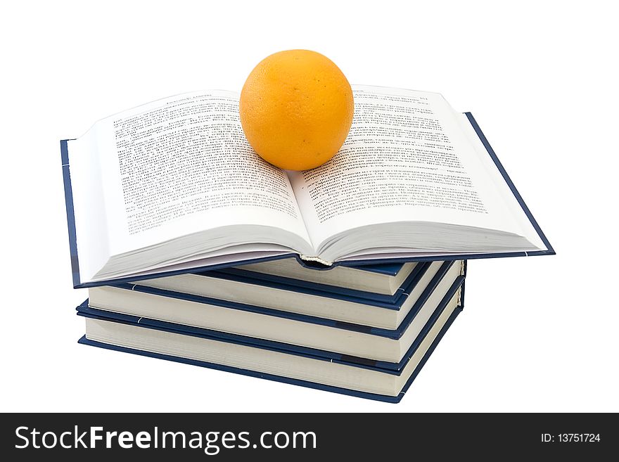 Pile of the books. The open book and orange. Pile of the books. The open book and orange