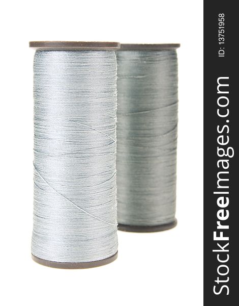 Large spools of thread on a white background