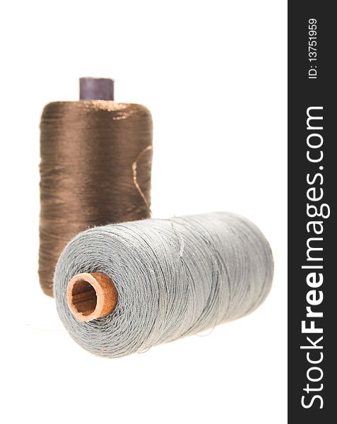 Large spools of thread on a white background