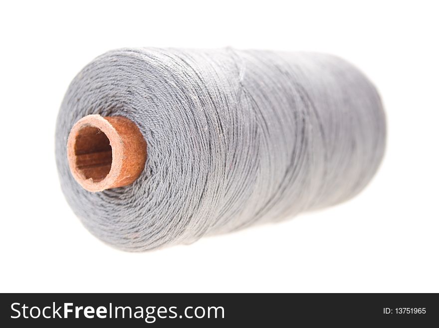 Large spools of thread on a white background