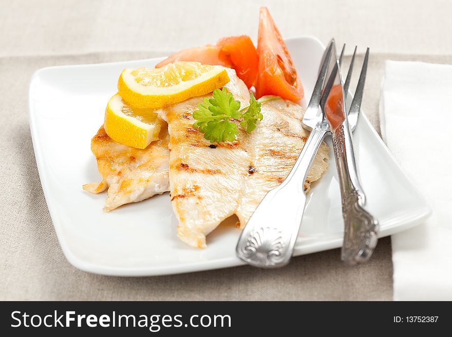 Filet grilled chicken with tomato and parsley