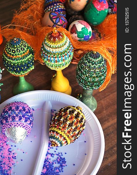 Several wooden easter eggs with beads wickework