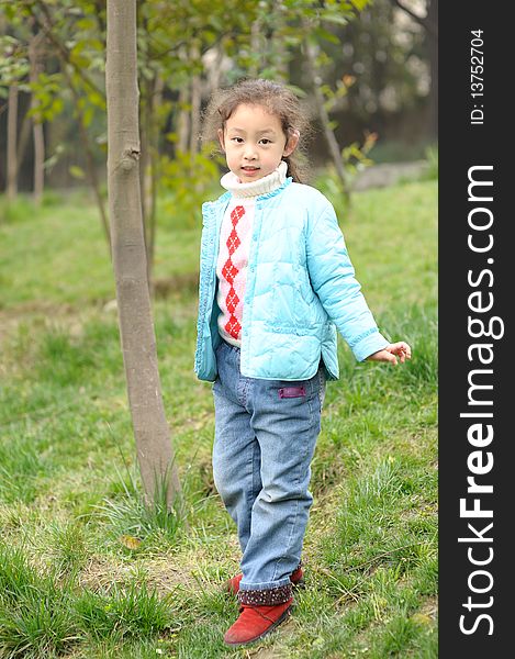 Cute little asian girl on green grass. Cute little asian girl on green grass.