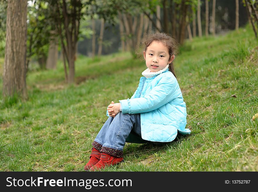 Cute Little Asian Girl On Grass
