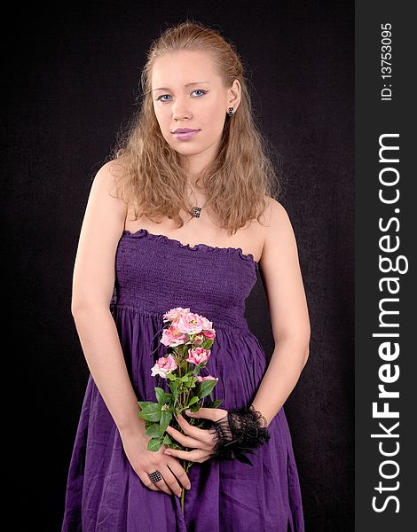 Portrait of a young girl with a flower roses. Portrait of a young girl with a flower roses