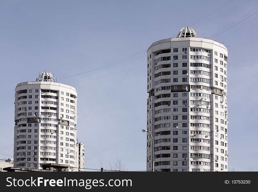 Two high-rise buildings against the blue sky. Two high-rise buildings against the blue sky