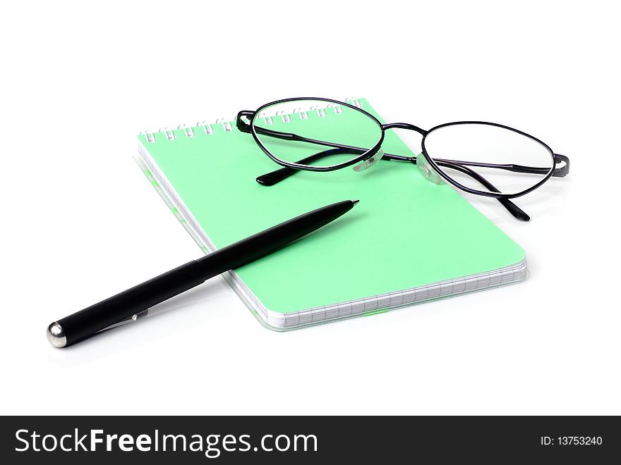 Glasses,pen and a notebook on a white background. Glasses,pen and a notebook on a white background