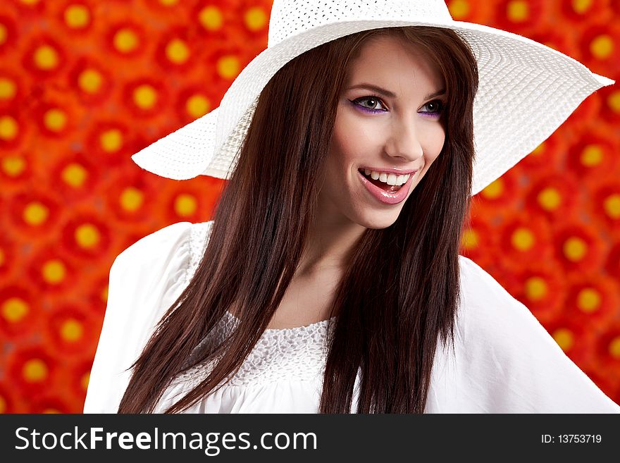 Summer woman over red flowers wall