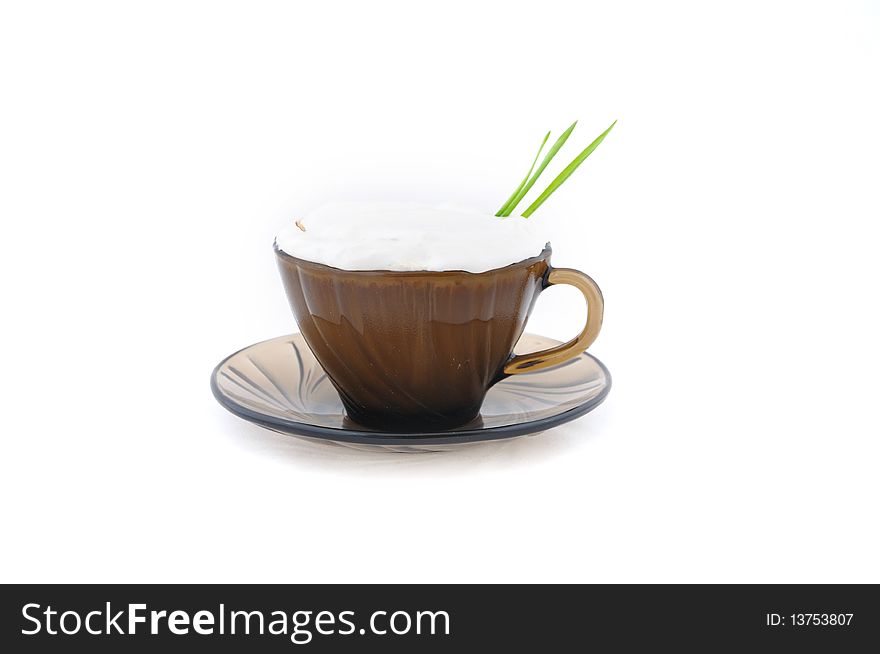 Cappuccino coffee with green blade on white isolate background