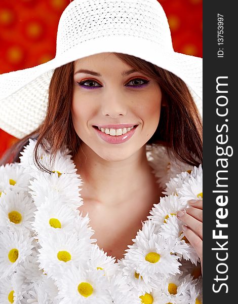 Spring woman dressed flower coat posing on flowers background