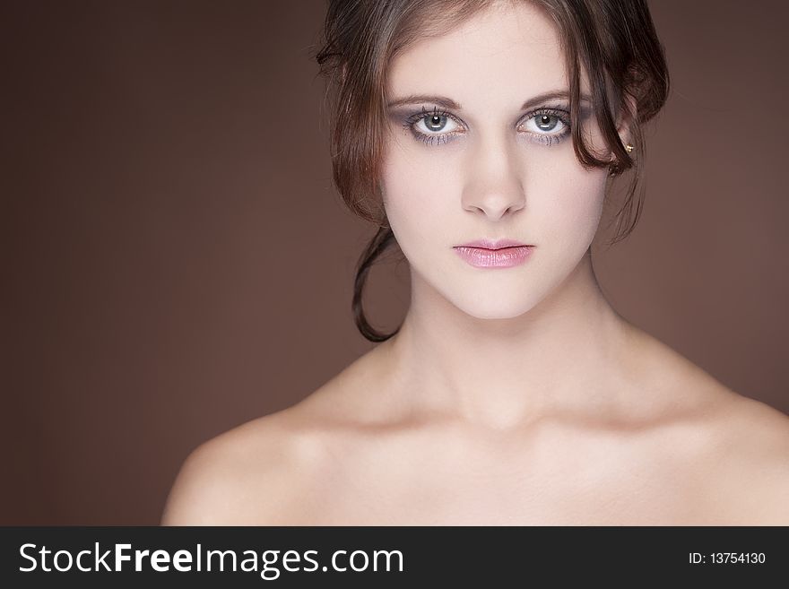 Beautiful young woman on brown background. Beautiful young woman on brown background