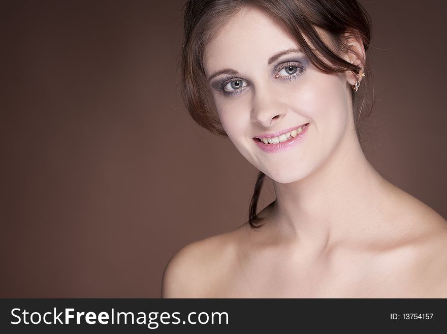 Portrait of smiling beuty girl on brown background. Portrait of smiling beuty girl on brown background