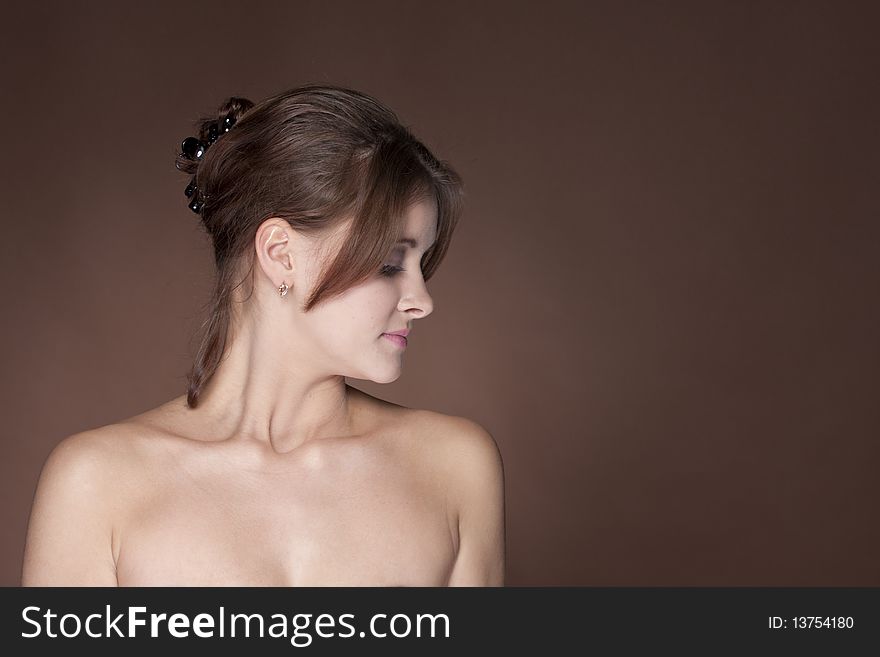 Beautiful young female face on brown background. Beautiful young female face on brown background