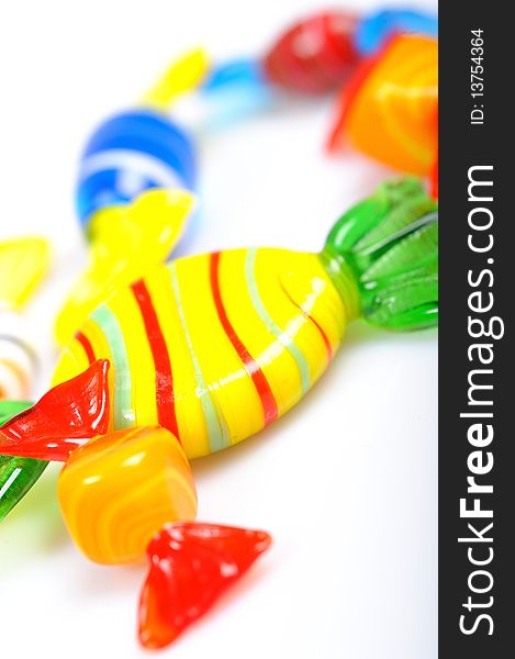 Delicious multi colored candies on white background