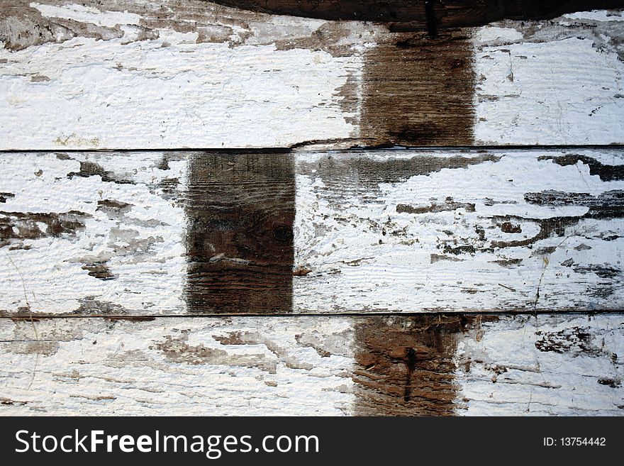 White-washed old floorboards of a barn with peeling paint and signs of age. White-washed old floorboards of a barn with peeling paint and signs of age.