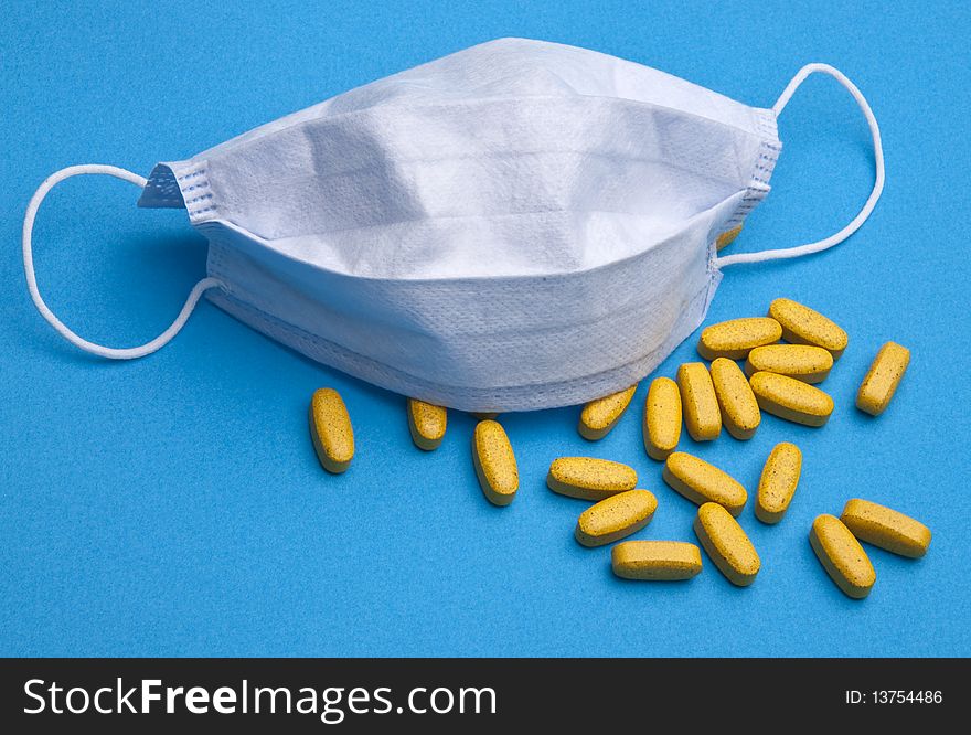 Surgical mask and pills for a health care concept. Surgical mask and pills for a health care concept.