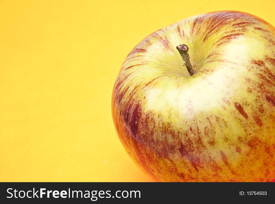 Apple on a vibrant yellow background. Apple on a vibrant yellow background.