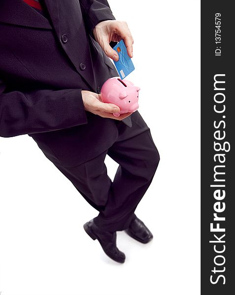 Businessman holding piggy bank and credit card. Businessman holding piggy bank and credit card