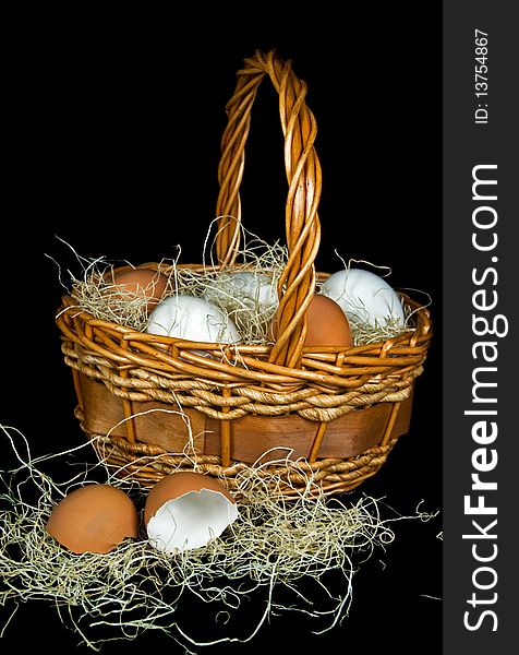 Brown and white eggs in a wicker basket. Brown and white eggs in a wicker basket.