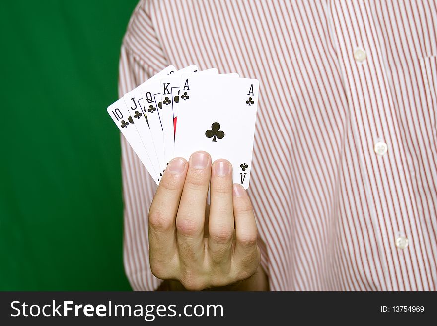 A young man in a red striped shirt, holding Royal flush