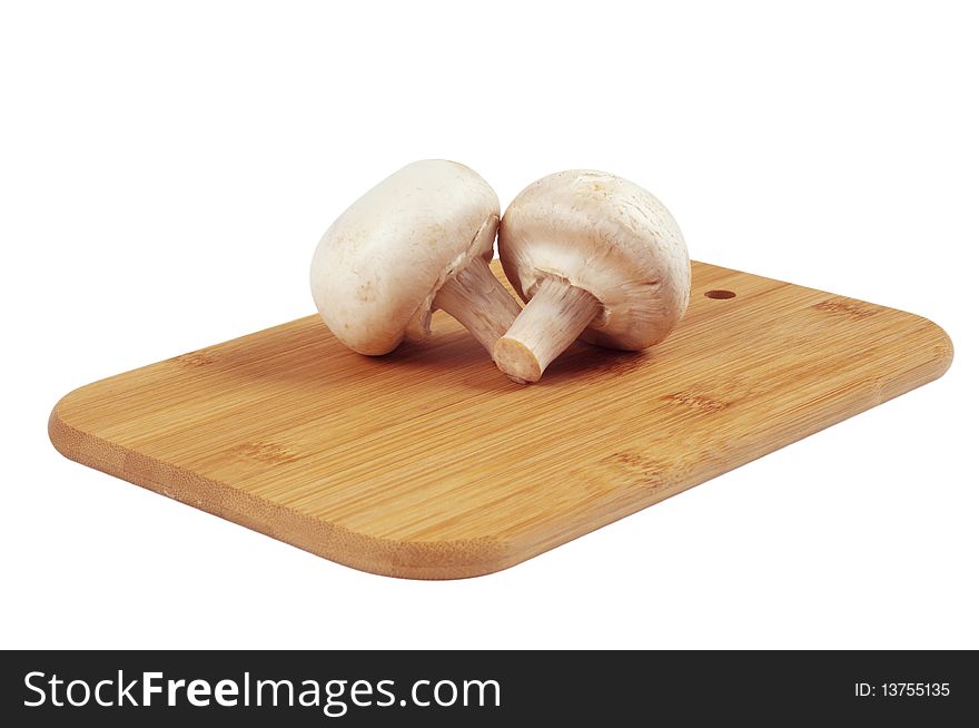 Mushrooms on a wooden board isolated on white. Mushrooms on a wooden board isolated on white