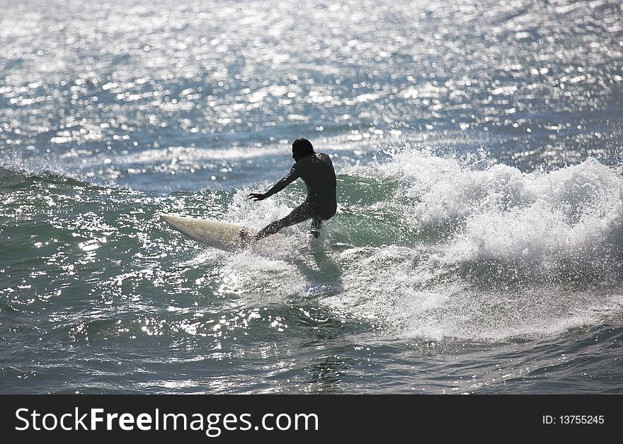 Surfer rides a wave