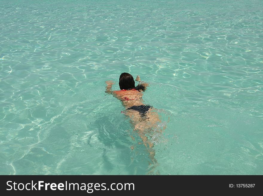 Girl swimming in saona beach