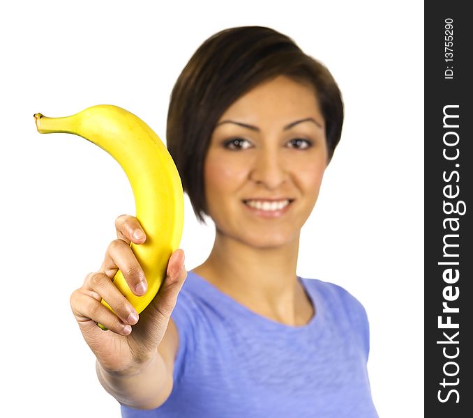 A happy young woman holds up a banana. A happy young woman holds up a banana