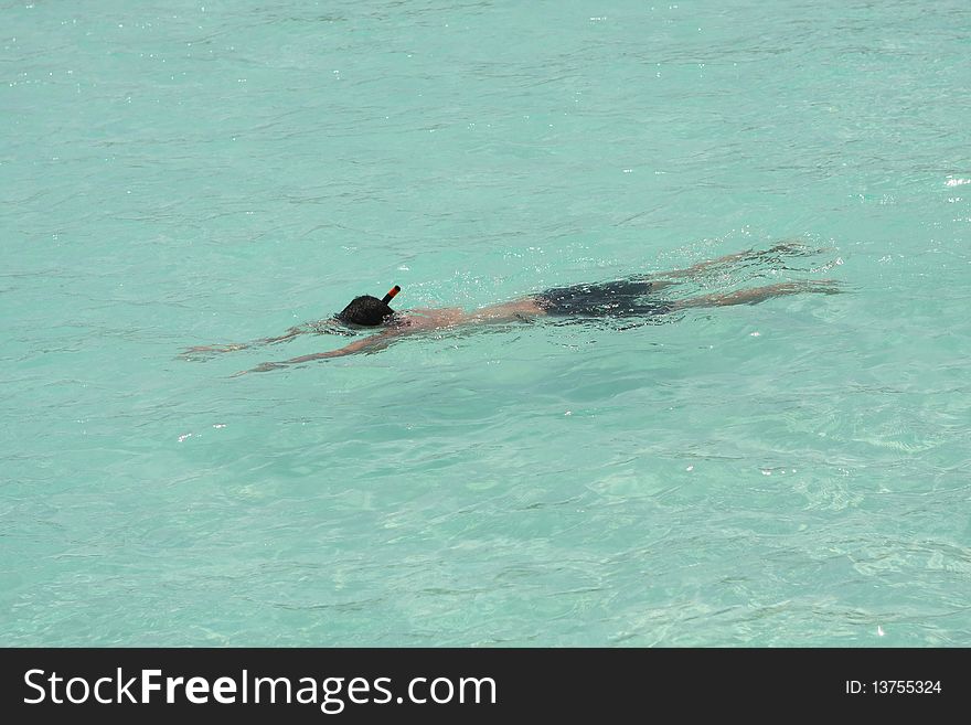 Man snorkeling in crystal clear