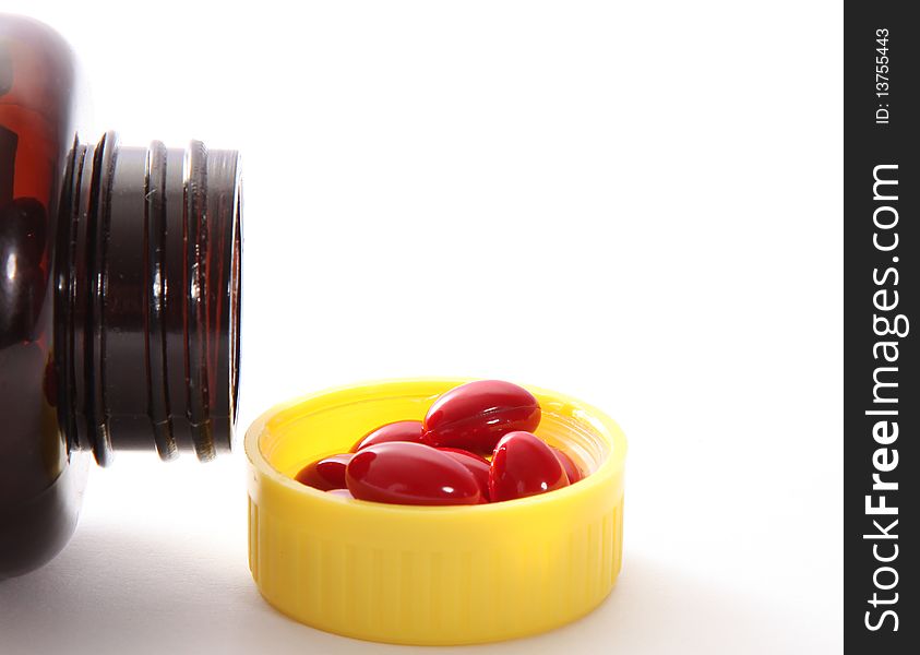 Packaging red capsules on white background. health image