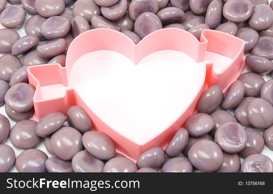 A heart with an arrow template is surrounded by purple serenity rocks. A heart with an arrow template is surrounded by purple serenity rocks.