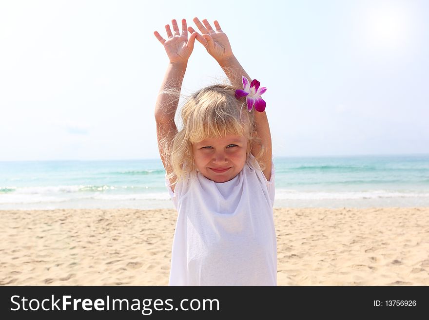 Beautiful little girl on the beach with orchid. Beautiful little girl on the beach with orchid