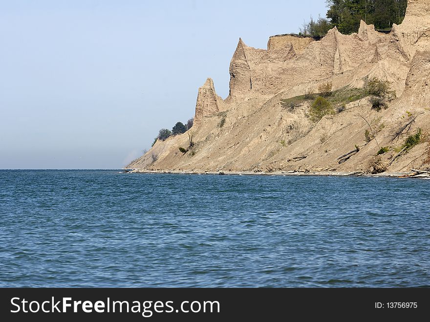 Jagged sandstone cliffs along an ocean coast showing shoreline erosion. Horizontal shot. Jagged sandstone cliffs along an ocean coast showing shoreline erosion. Horizontal shot.