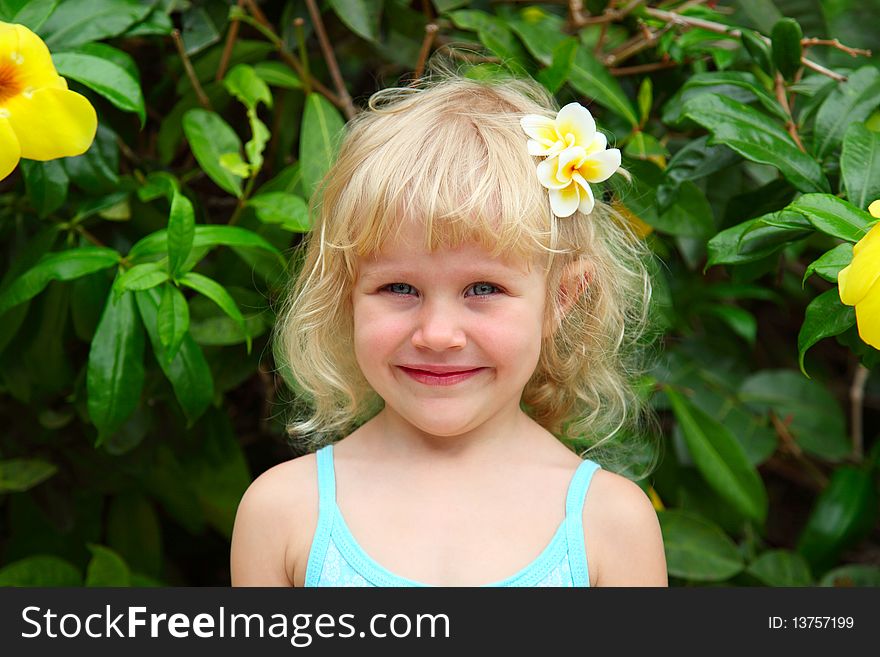 Portrait of a beautiful little girl with plumeria