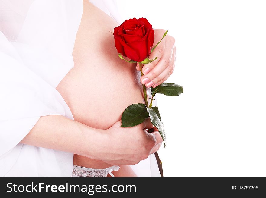 Pregnant woman holding her belly and flower rose