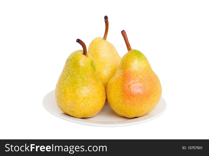 Three pears lie on a plate isolated on a white background.