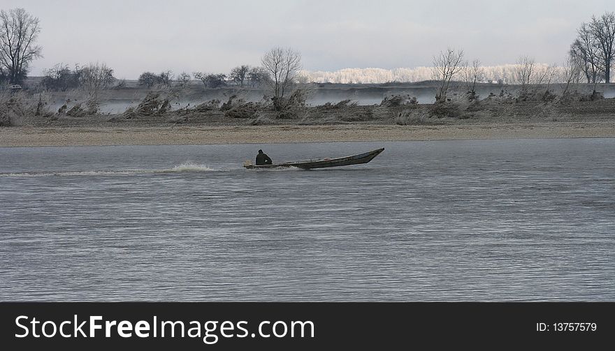 Winter river in Siberia and the motorboat