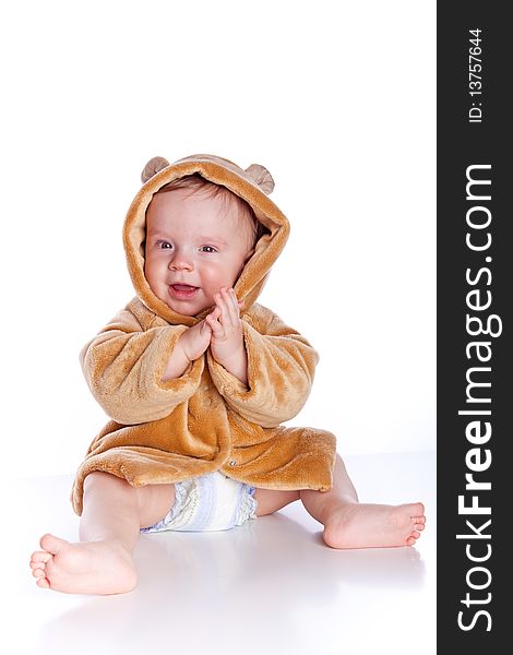 Portrait of young boy sitting isolated over a white background