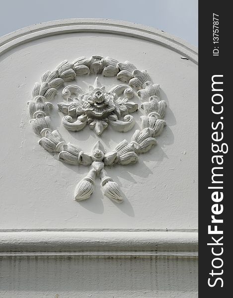 Symbol of the steering wheel and flowers. The entrance to the church door in Thailand. Symbol of the steering wheel and flowers. The entrance to the church door in Thailand.