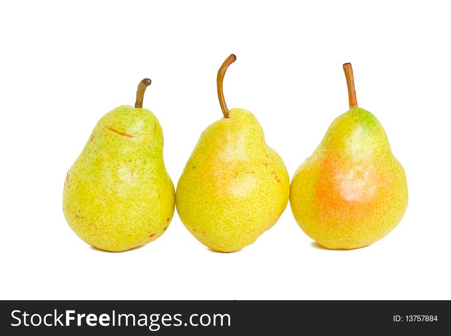 Three delicious yellow pears on a white background. Three delicious yellow pears on a white background.