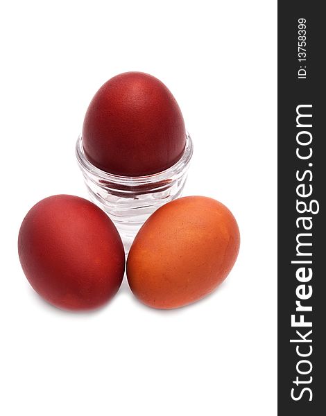 Red Easter egg in a glass stand on a white background